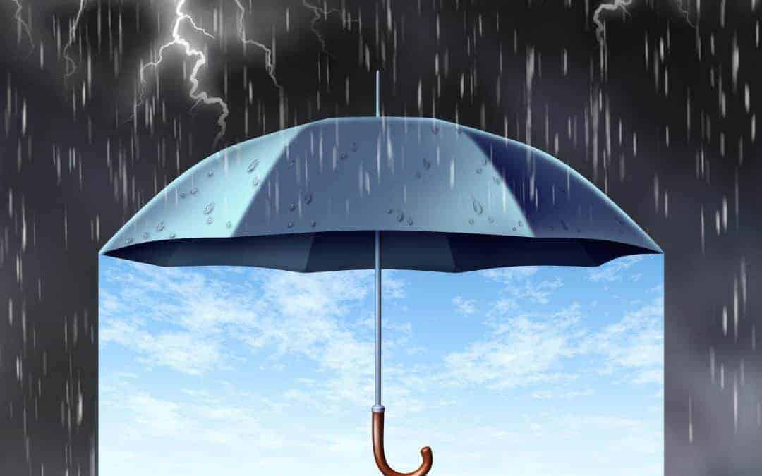 Umbrella in a storm on a dark night with sunshine coming through underneath the umbrella