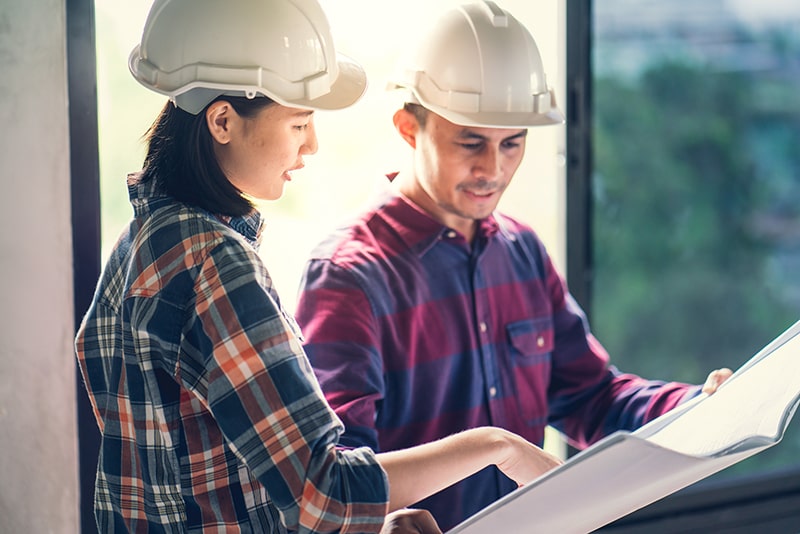 man and woman reviewing safety standards of mobile home